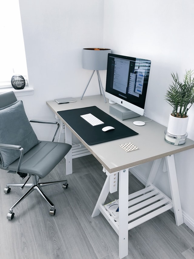 work desk, chair, computer, plant and lamp - the ingredients of an effective home workspace.  